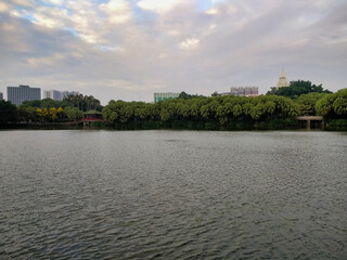 Fototapeta premium River in the park and houses on the building plan. Guangzhou. Guangdong. China. Asia