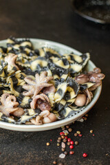 pasta farfalle ink cuttlefish seafood baby octopus small octopuses on the table meal snack ingredient top view copy space for text food background rustic