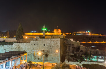 Fototapeta na wymiar Night view of Siliver dome of Al-Aqsa Mosque , built on top of the Temple Mount, known as Haram esh-Sharif in Islam and al-Fakhariyya Minaret and wall of old city of Jerusalem, Israel.