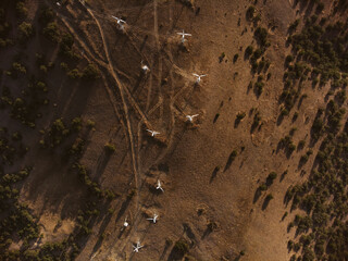 Aerial drone panorama shot of mountain area, windmills, the long and winding road through the mountains. Southern region, sands, desert 