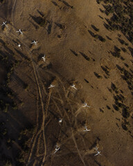 Aerial drone panorama shot of mountain area, windmills, the long and winding road through the mountains. Southern region, sands, desert 