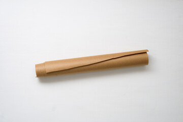 a roll of craft paper on a light background in the middle, copy space