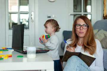 Mom and baby working from home. Lockdown concept.