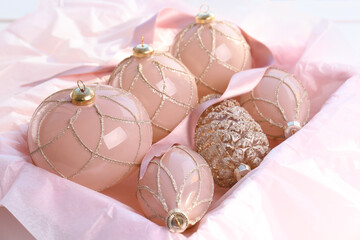 Set of beautiful Christmas baubles and ribbon in box, closeup