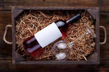 Rose wine bottles packed in open wooden box