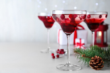 Delicious Christmas cocktail with liqueur on white table. Space for text