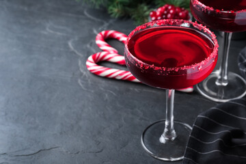 Delicious Christmas cocktail with liqueur on black table. Space for text
