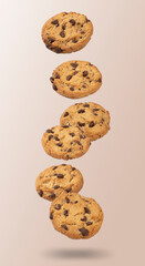 Chocolate chip cookies floating over light brown background