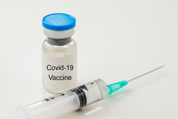 coronavirus vaccine and syringe on a white background