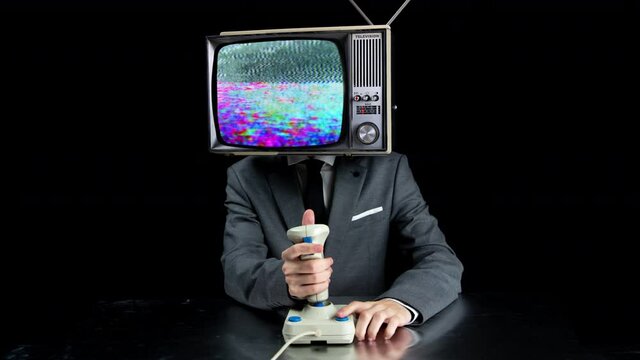 Man with TV on head playing video games