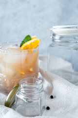 Fototapeta na wymiar Vertical shot of cocktail with orange and mint.