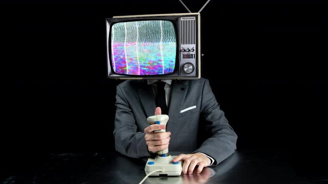 Man with TV on head playing video games