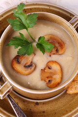 mushroom soup puree with crackers on a wooden table