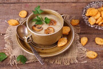 mushroom soup puree with crackers on a wooden table