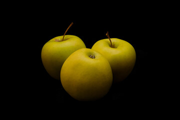 Yellow apple fruit on dark background