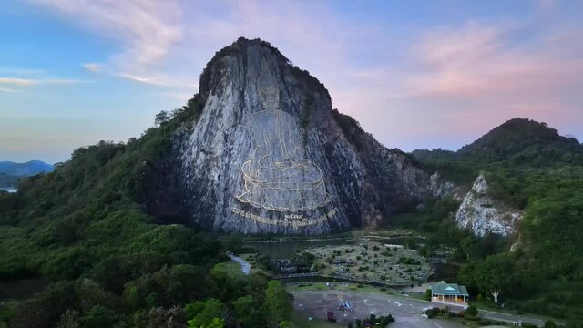 4k drone footage of Buddha Mountain in Pattaya where an image of Buddha, sitting cross-legged, was gold engraved into the northern face of a limestone hill in Khao Chi Chan, Thailand.