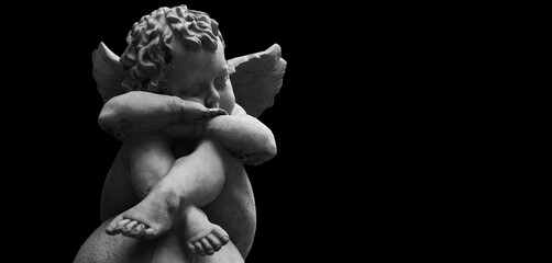 Little angel. Ancient stone statue. Copy space for design or text.