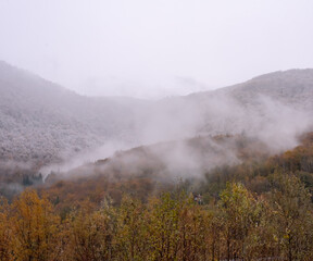 Landscape of mountains with cloudy sky and fog on a cloudy day. Autumn rainy day