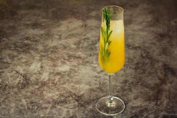 citrus cocktail with ice and rosemary close-up.