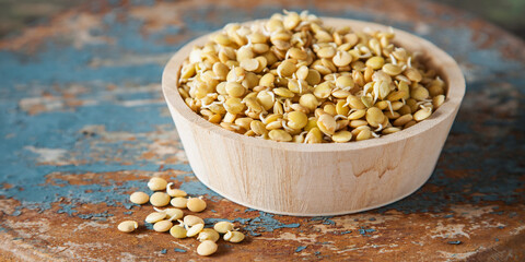 Sprouts, germinated seeds of lentil in a bowl on old wooden background. Banner