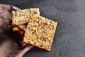 Multigrain crunchy crispbread on a dark concrete background.