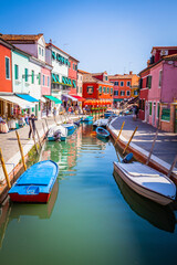 Fototapeta na wymiar Boats in the channels of Burano, colourful island in the bay of Venice, Italy