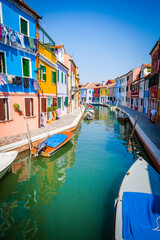 Boats in the channels of Burano, colourful island in the bay of Venice, Italy