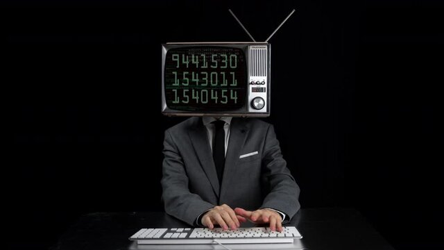 Man typing with TV on head showing numbers on screen 