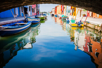 Fototapeta na wymiar Reflecion in the channels of Burano, colourful island in the bay of Venice, Italy