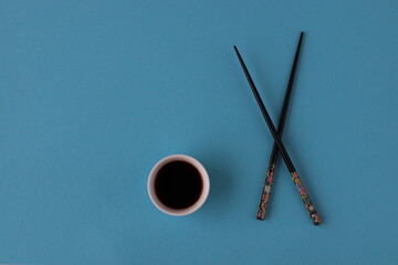 Black chopsticks isolated with soy sauce. 