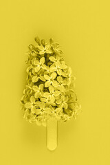 Lilac flowers in trendy 2021 new colors Illuminating Yellow. Color of the Year 2021. Greeting card. Minimalism fashion style. Copy space, flat lay.