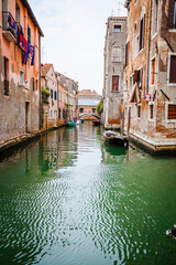Boats and ancient houses in the channels of Venice, Venetian, Italy