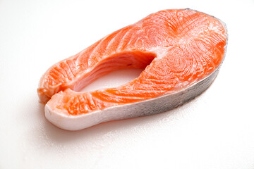salmon sliced into pieces on white background. red fish. fresh trout for cooking.