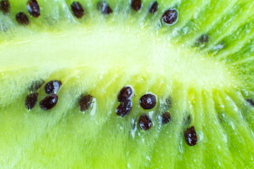Close up photo of kiwi background. Kiwi fruit cut in half with seeds inside, macro view.