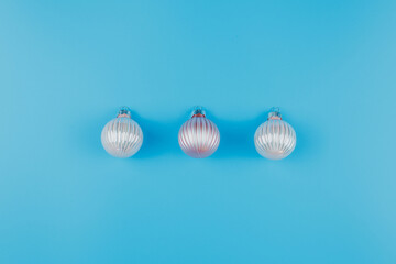 Christmas or New Years minimalistic background, with Christmas balls on blue.