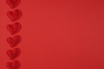 Obraz na płótnie Canvas Valentine's day concept with hearts on a red background. Flat lay, copy space
