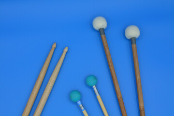 Percussion mallets set on a blue background.