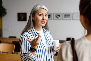 Two employee standing in social distance wearing face mask