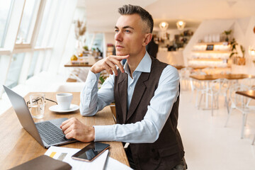 Confident handsome businessman in smart clothes