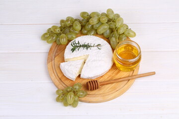 Camembert with toasted baguette on white background
