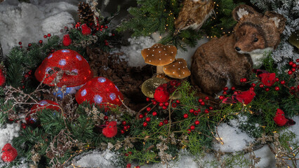 Christmas toys in the form of mushrooms, birds and small fox. Decorated christmas tree background. Happy new year concept.