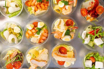 catering table. Furshet. A variety of salads in plastic cups