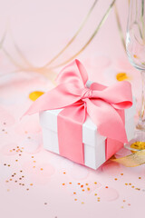 Gift or present box on pink table top view. Flat lay composition for birthday, mother day, black friday sale, xmas, christmas, wedding, valentine day, new year, banner