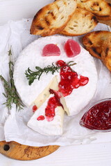 Camembert with grilled baguette and raspberry jam and wine