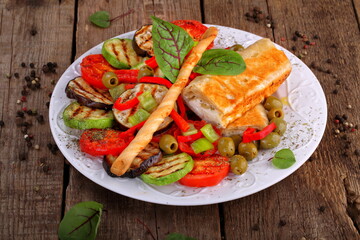 Dish of grilled vegetables with cheese wrapped in pita bread
