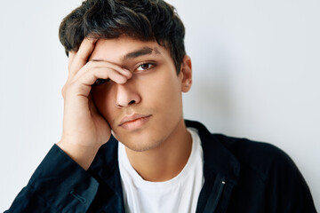 Close up portrait of young thoughtful man on white background