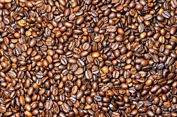 Bright photo of coffee seeds background.  Roasted brown coffee beans.  A lot of coffee.
