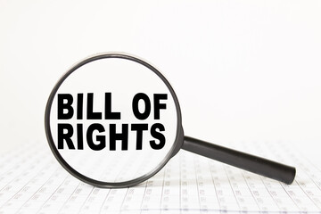 words BILL OF RIGHTS in a magnifying glass on a white background. business concept