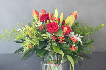 Bouquet of red flowers on a gray background texture