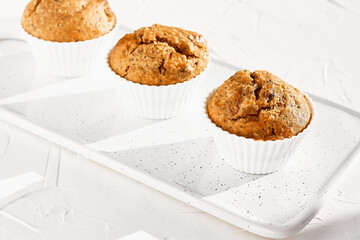 Homemade muffins with ginger and nuts on white table. Healthy eating, gluten free.Homemade tasty dessert or breakfast for Valentine's day,Mother's day